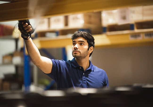 Man scanning items in warehouse